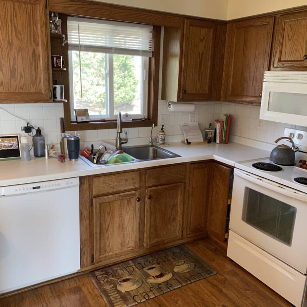 Before photo of kitchen cabinets before painting by Empire Painting