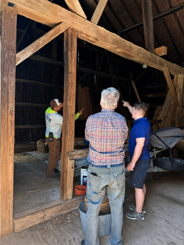 Dan Brooks on site with a customer and Empire Painting team member