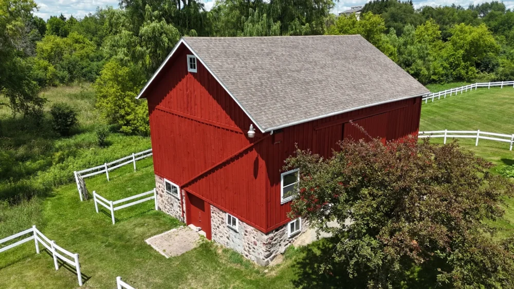 Red barn staining drone photo in Erin Wisconsin by Empire Painting