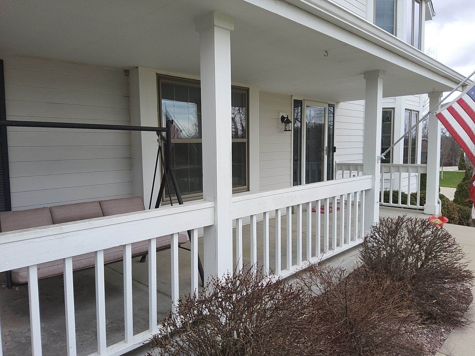 Front porch railings, columns and siding on a Germantown WI home before exterior painting
