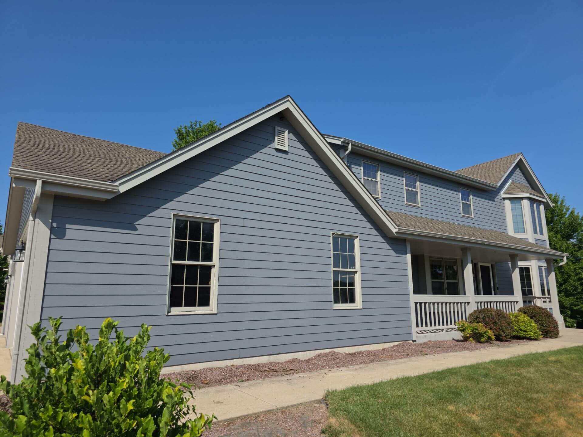 Finished blue-gray home exterior with white trim in Germantown WI