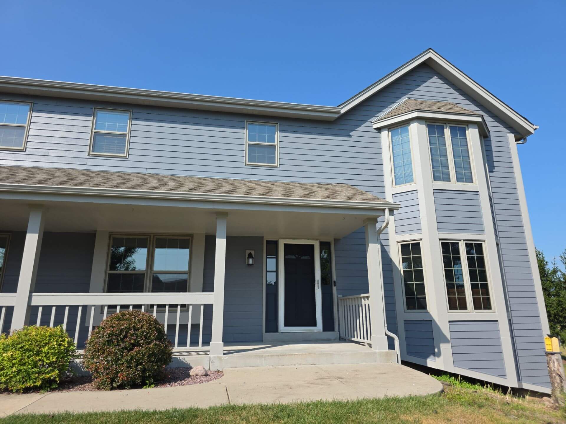 Finished front exterior and bay window after house painting in Germantown WI
