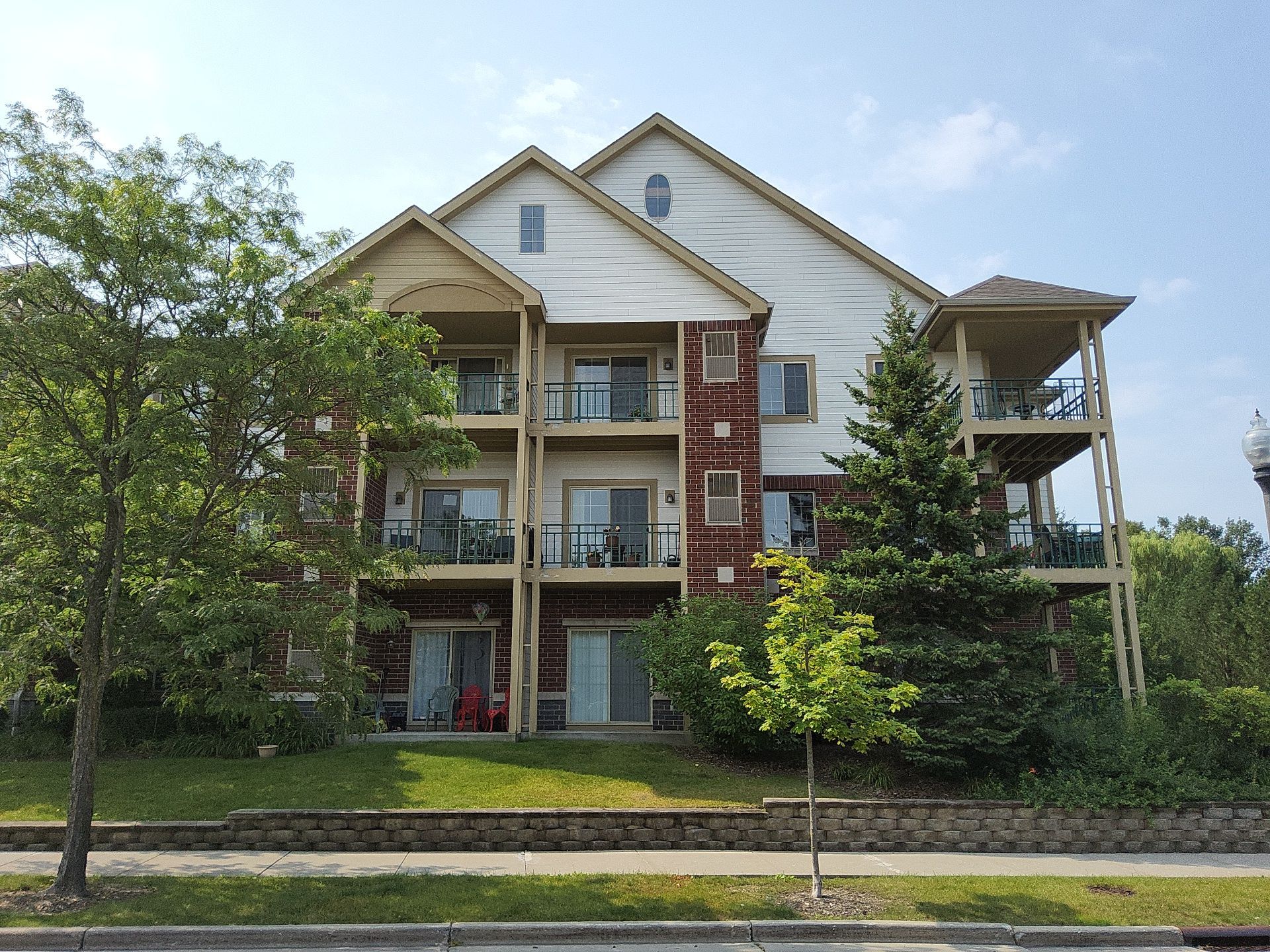 Brookfield condo building with painted siding, gables and balconies