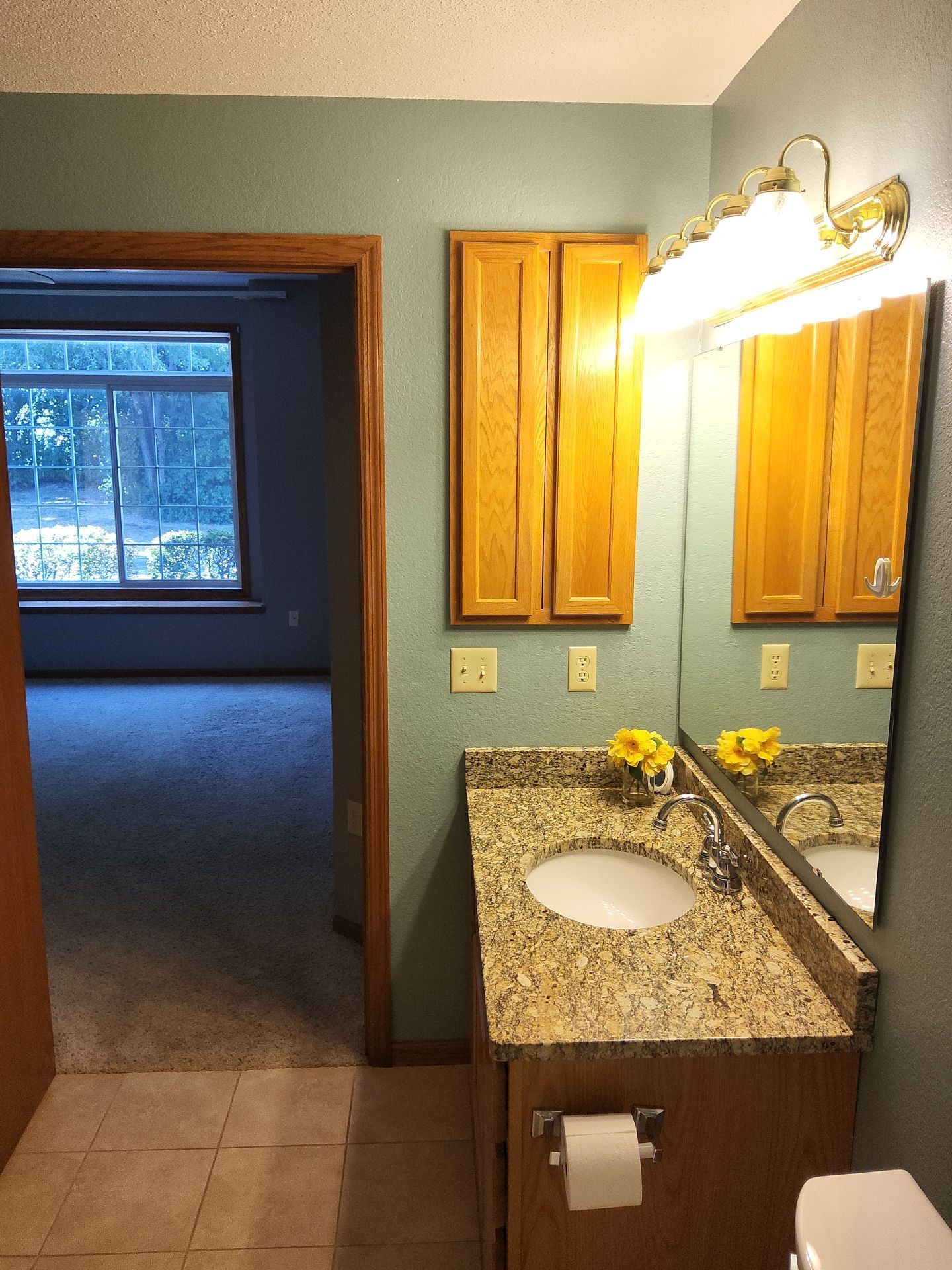 Blue-green bathroom walls beside warm wood trim at the Nashotah property