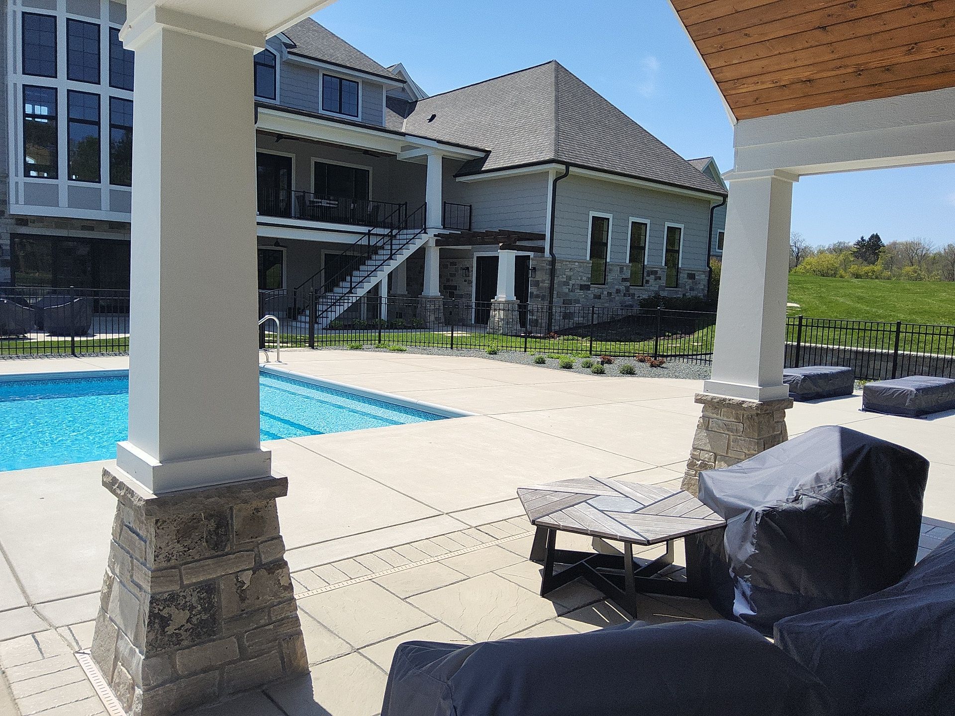 Poolside view of the New Berlin home and rear stairs