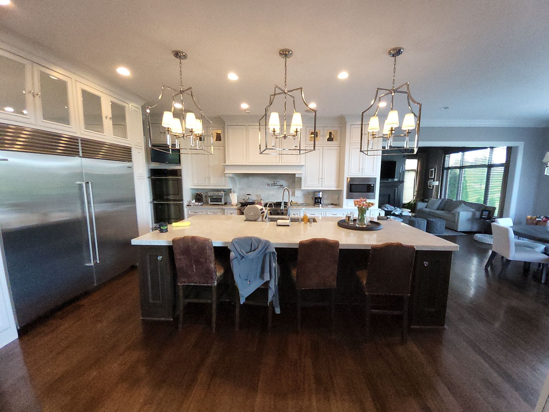 Light cabinets and dark island viewed from the seating side in a Hartland Wisconsin kitchen