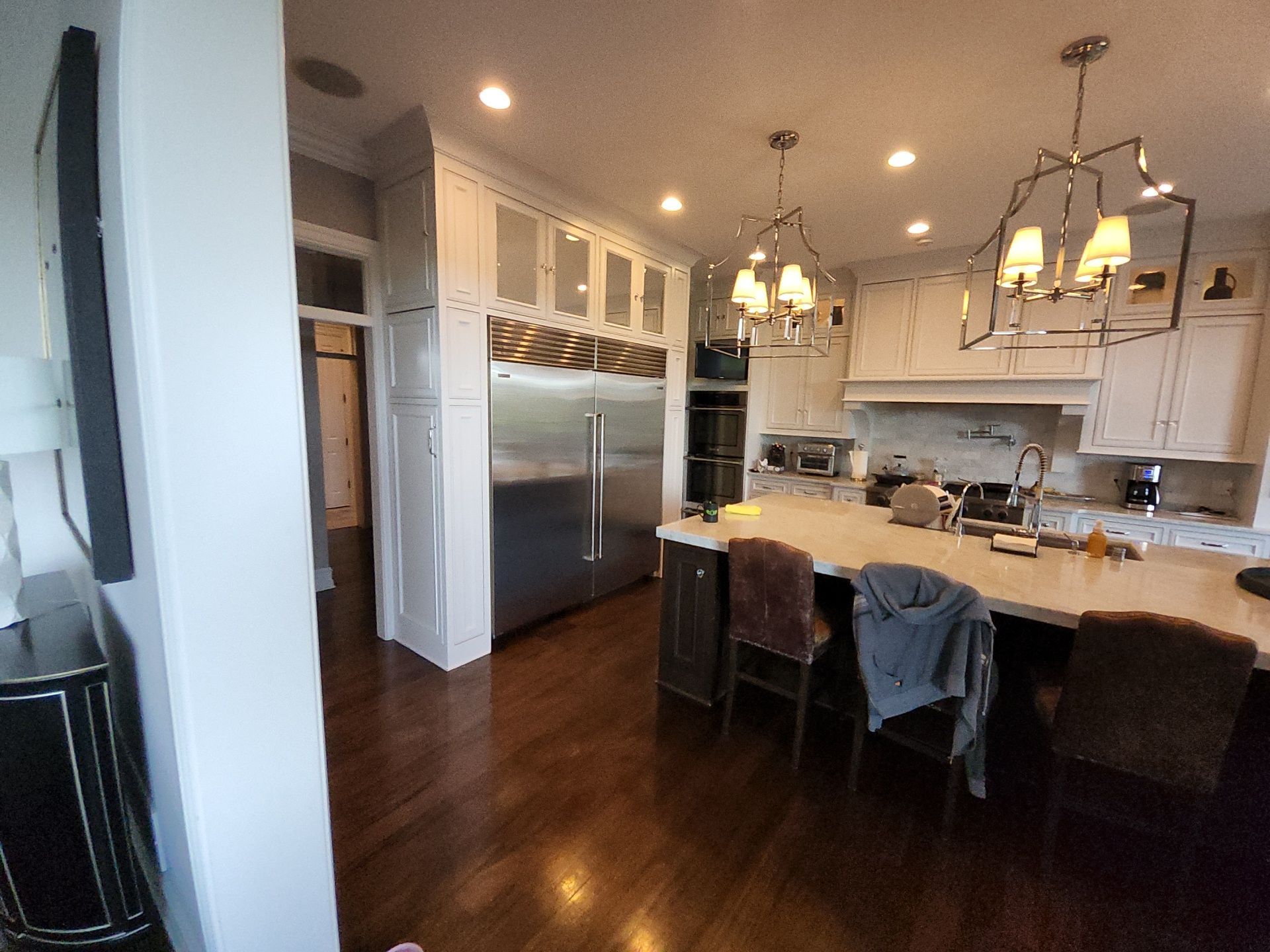 Tall light cabinet surrounds beside the refrigerator in a Hartland Wisconsin kitchen