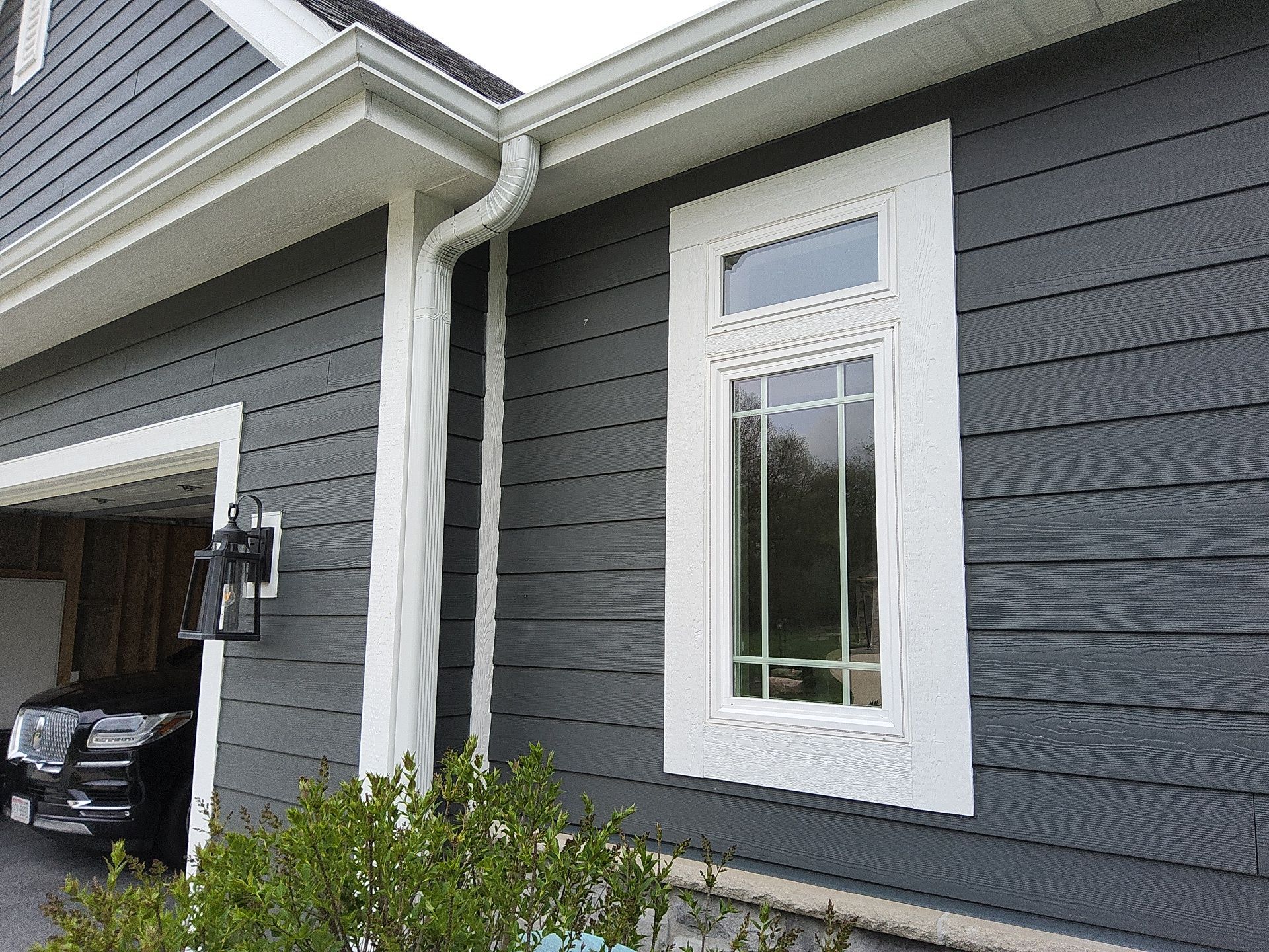 Window and white trim beside the garage in Wales, Wisconsin