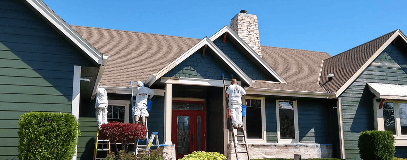 Empire Painting crew working on the siding and trim of a Milwaukee-area home.