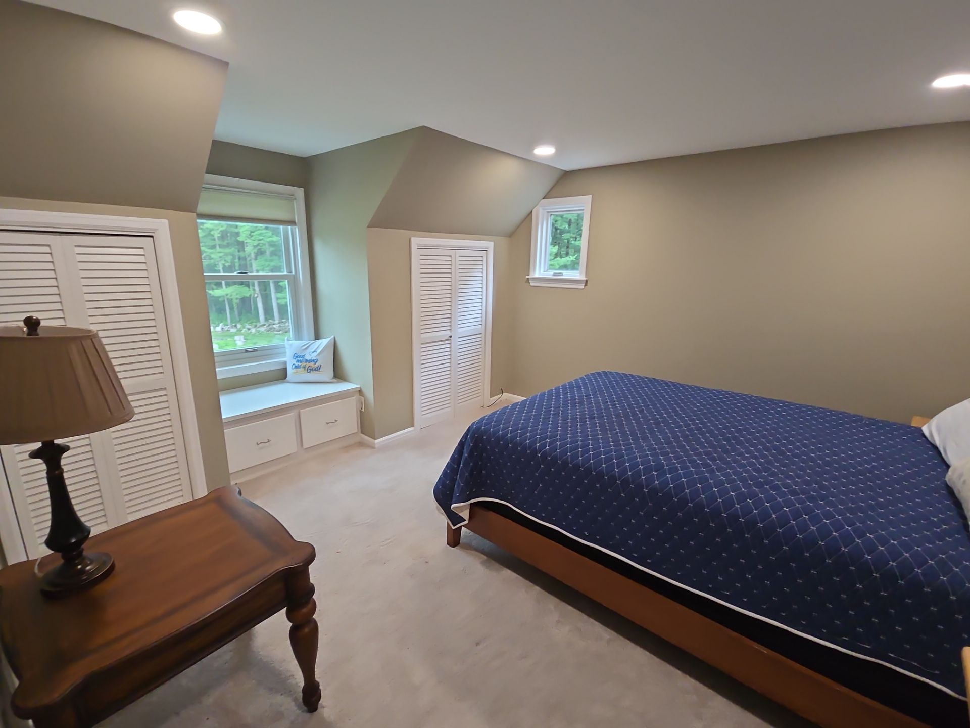 Nashotah bedroom with neutral walls, white closet doors and a window seat