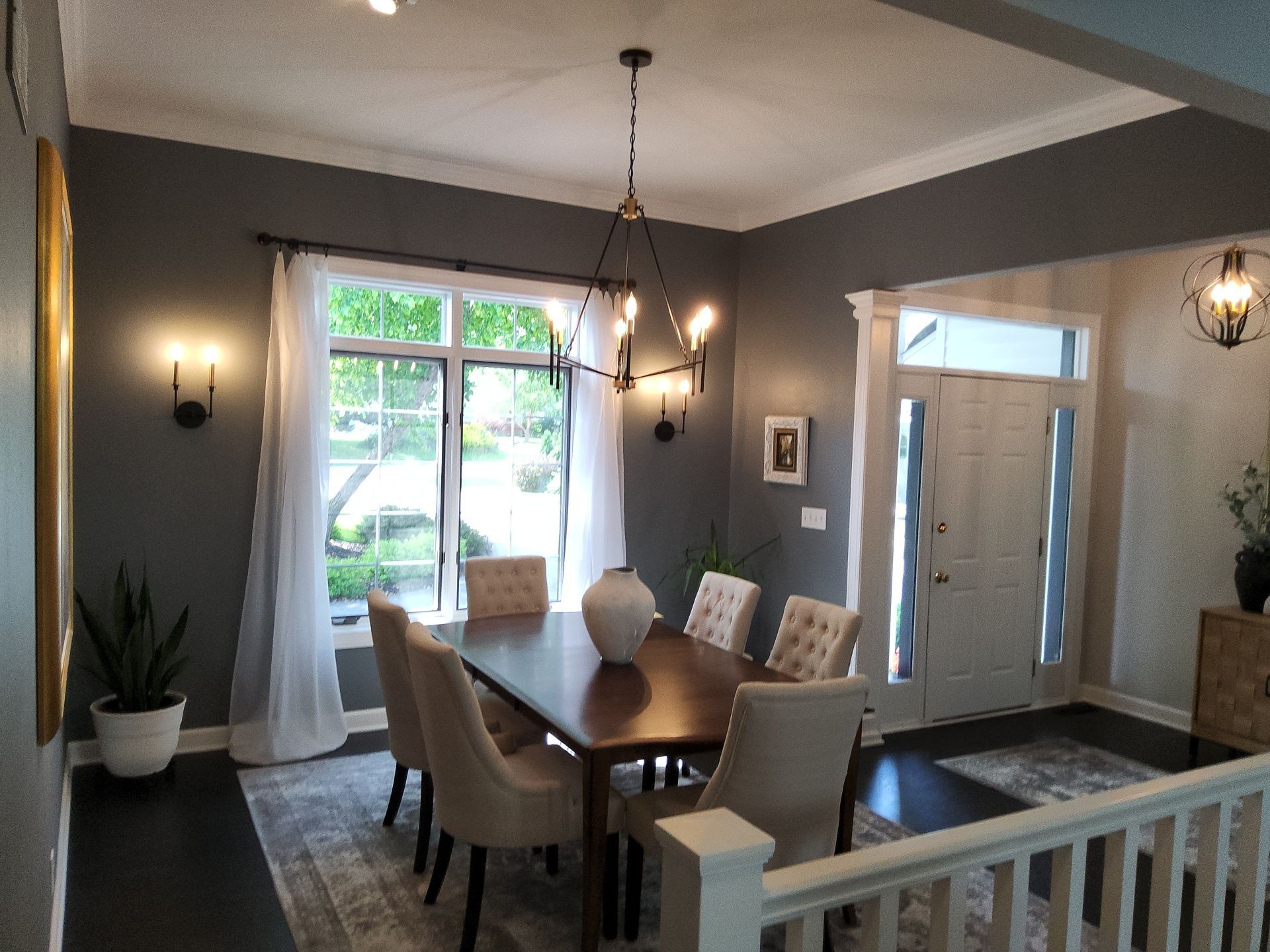 Gray dining room walls with white crown molding and window trim in Nashotah