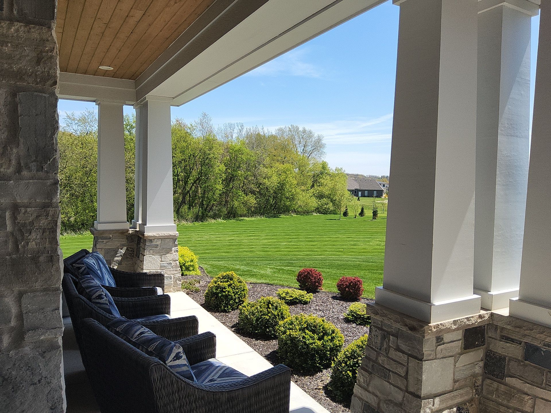White porch columns with stone bases at a New Berlin home