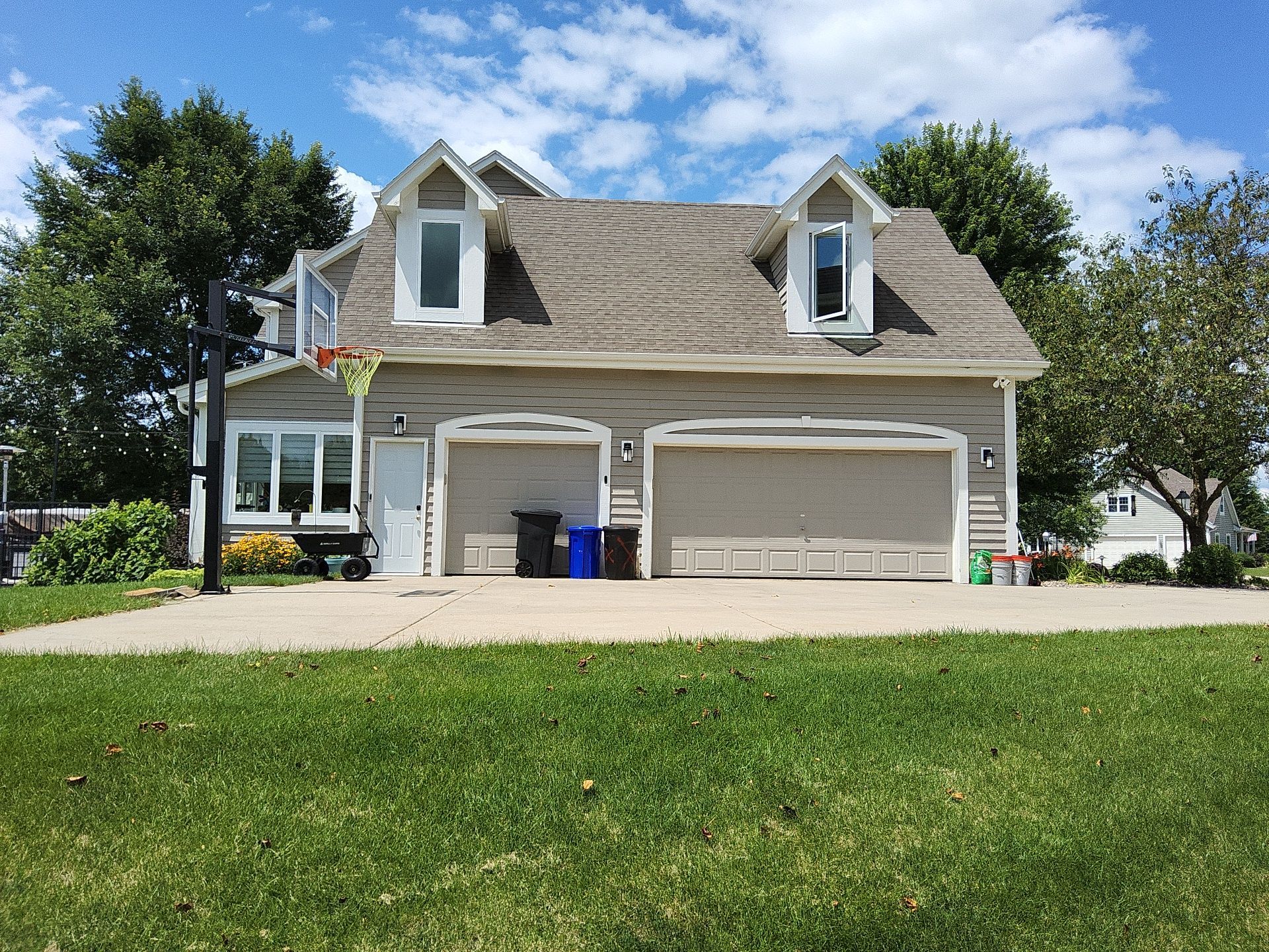 Nashotah garage exterior with white dormer and door trim