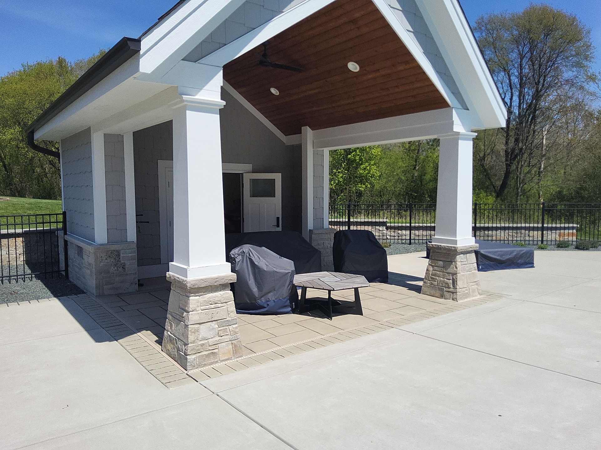 New Berlin pool house with freshly painted white pillars and trim