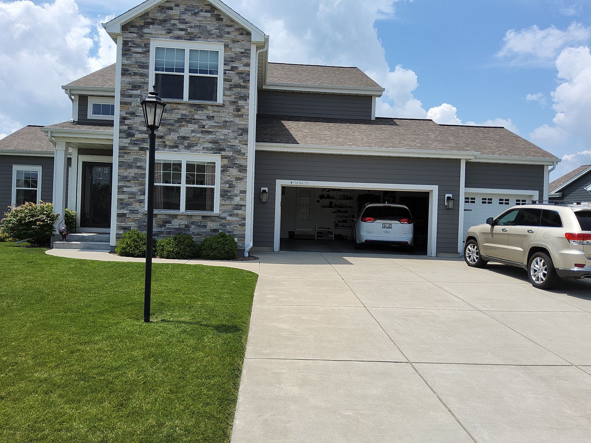 Gray home with a stone chimney and white trim on Weyer Farm Drive.