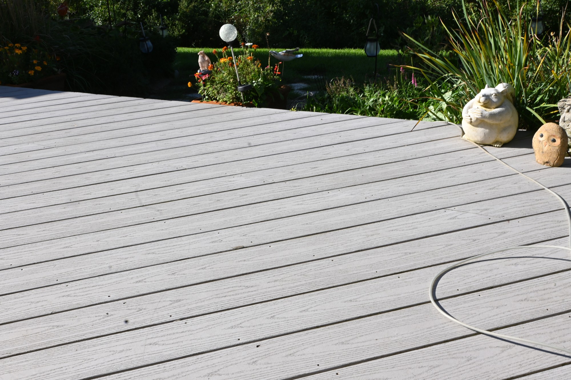 Gray deck boards beside the backyard garden at the Brookfield home