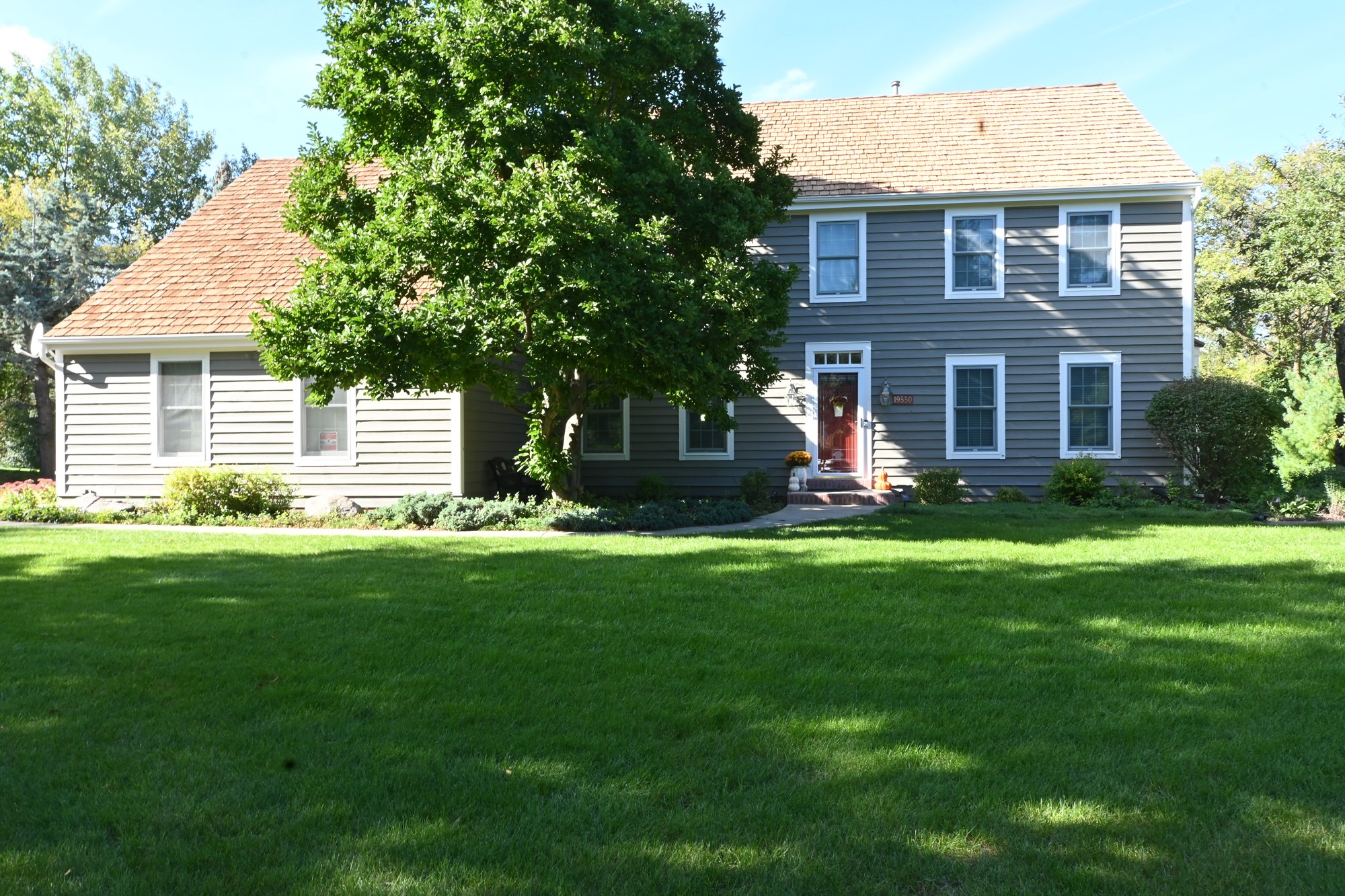 Front of a Brookfield home with gray exterior siding and white trim after painting by Empire Painting