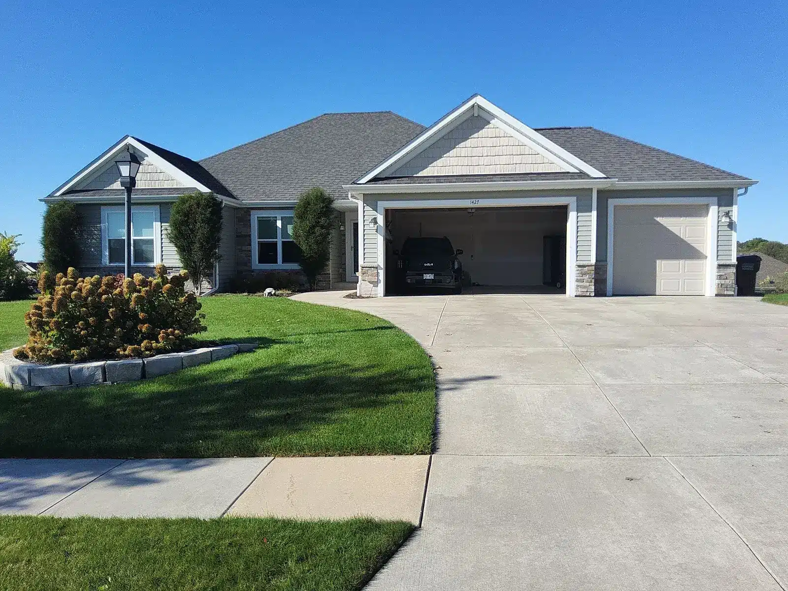 Front of a home with gray siding and white trim in Mukwonago