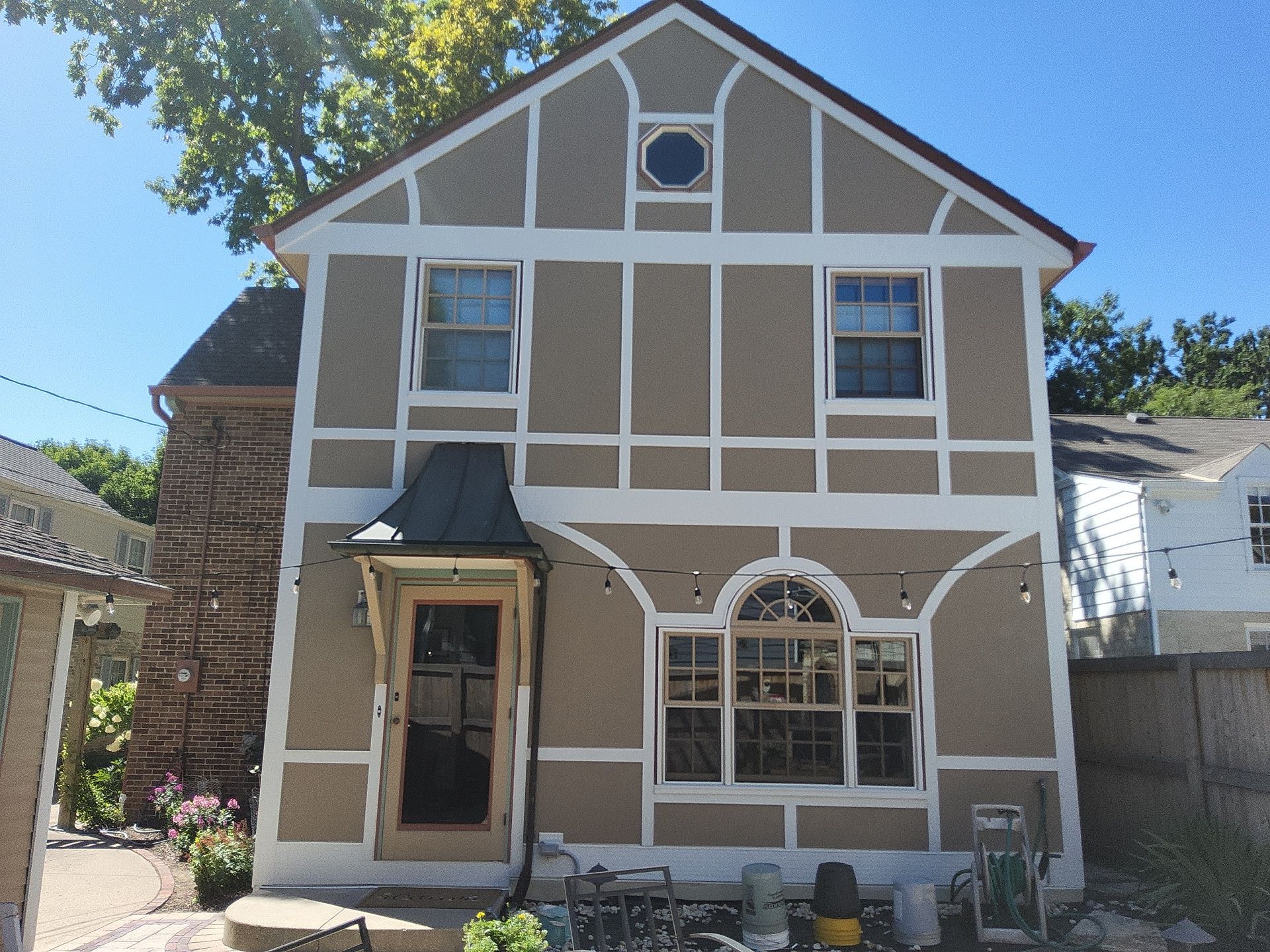 Tan exterior panels and white trim on the rear elevation of a Whitefish Bay home