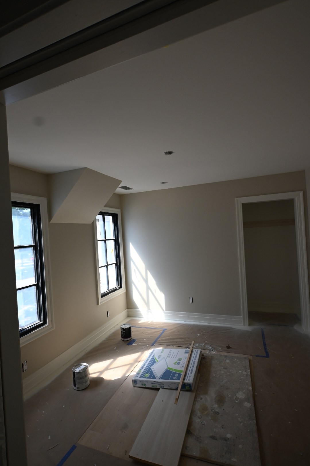 Interior room with protected flooring and work still underway