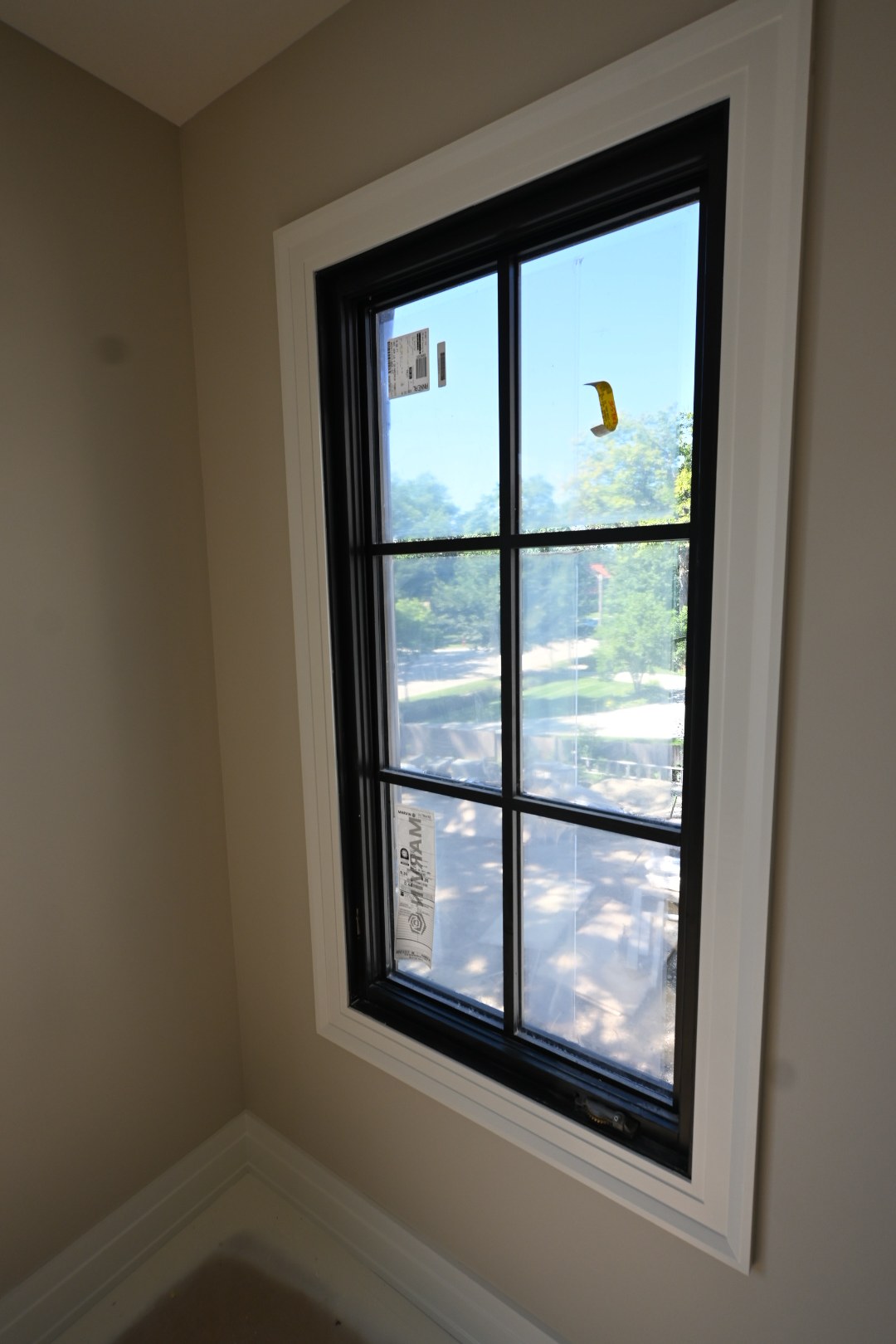 Dark window frame surrounded by light interior trim