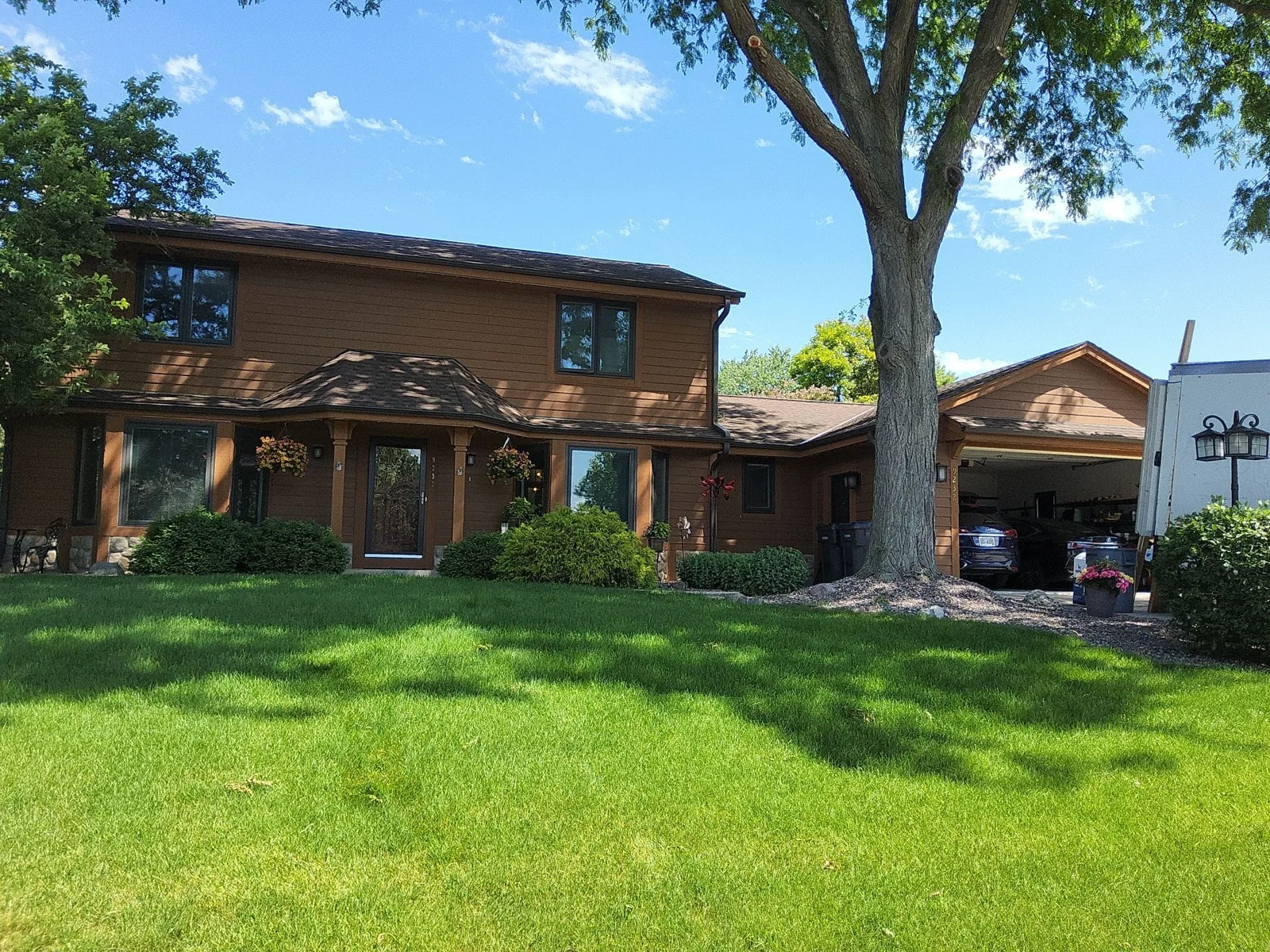 After: Mequon home with freshly painted cement-board siding and stained cedar trim