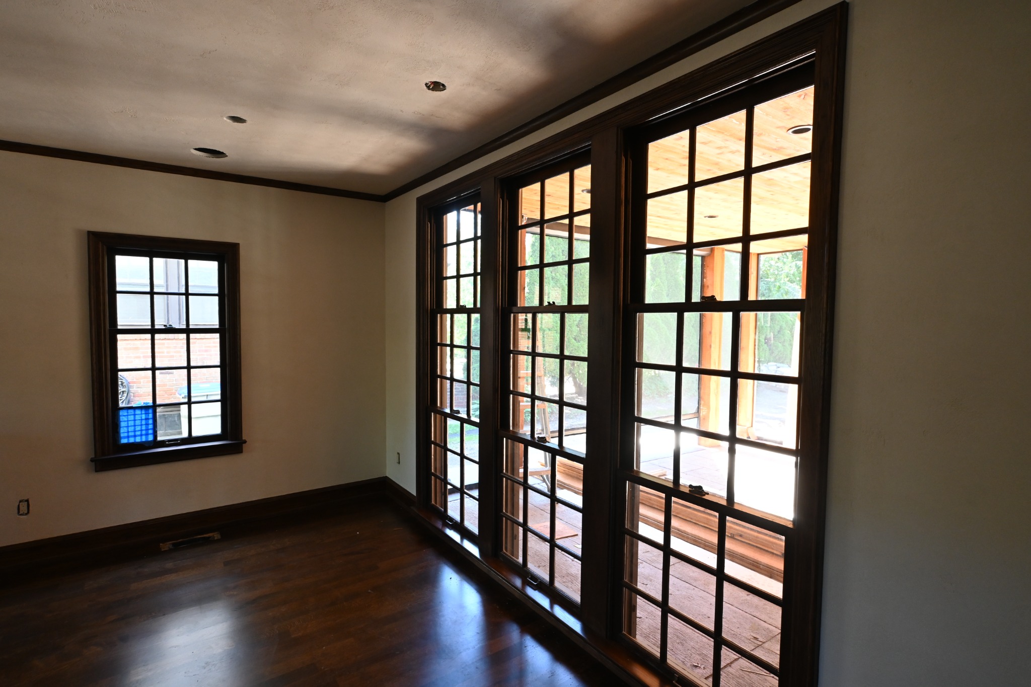 Multi-pane windows and French doors with dark stained wood frames in Whitefish Bay
