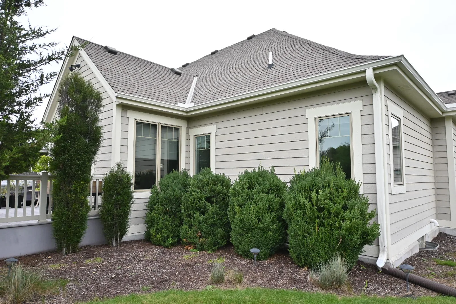 Gray lap siding and white window and corner trim on the repainted Pewaukee home