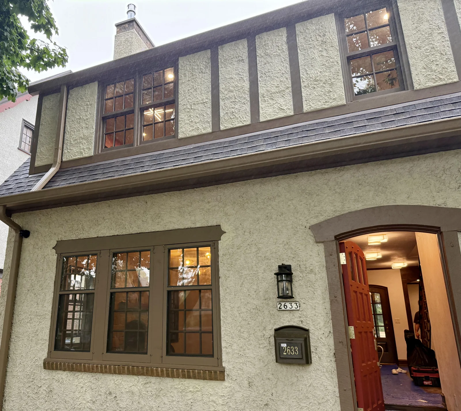 Whitefish Bay home with light stucco and dark wood trim