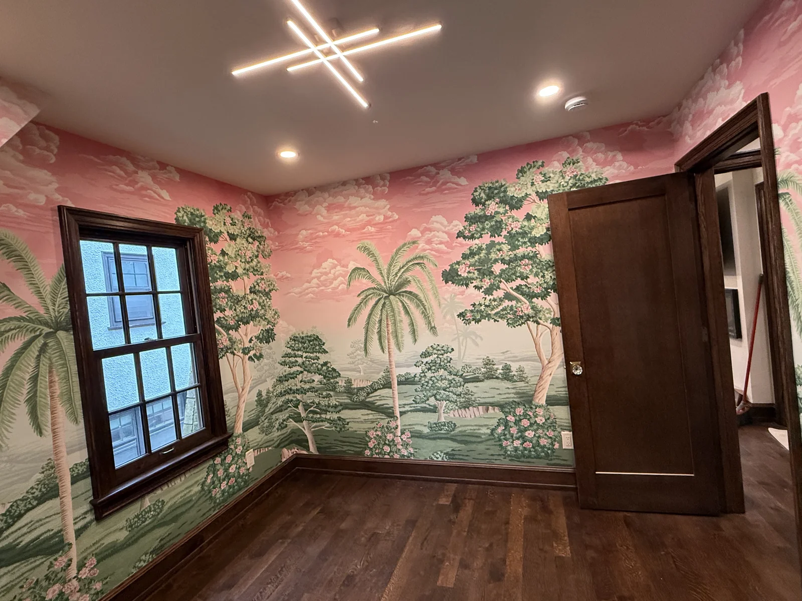 Dark stained window trim and door beside patterned walls in a Whitefish Bay home