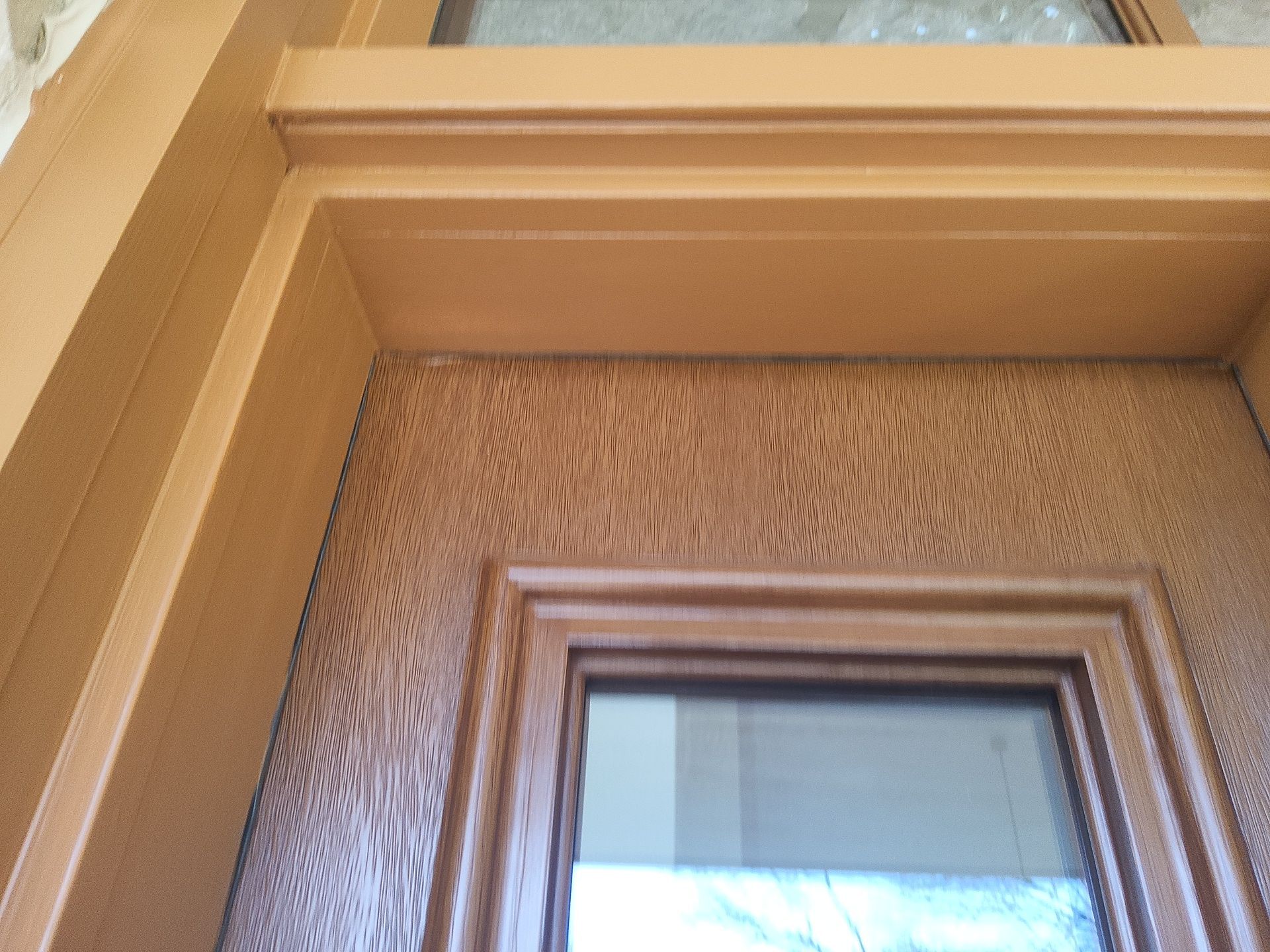 Wood entry door finish and trim detail at a Colgate home