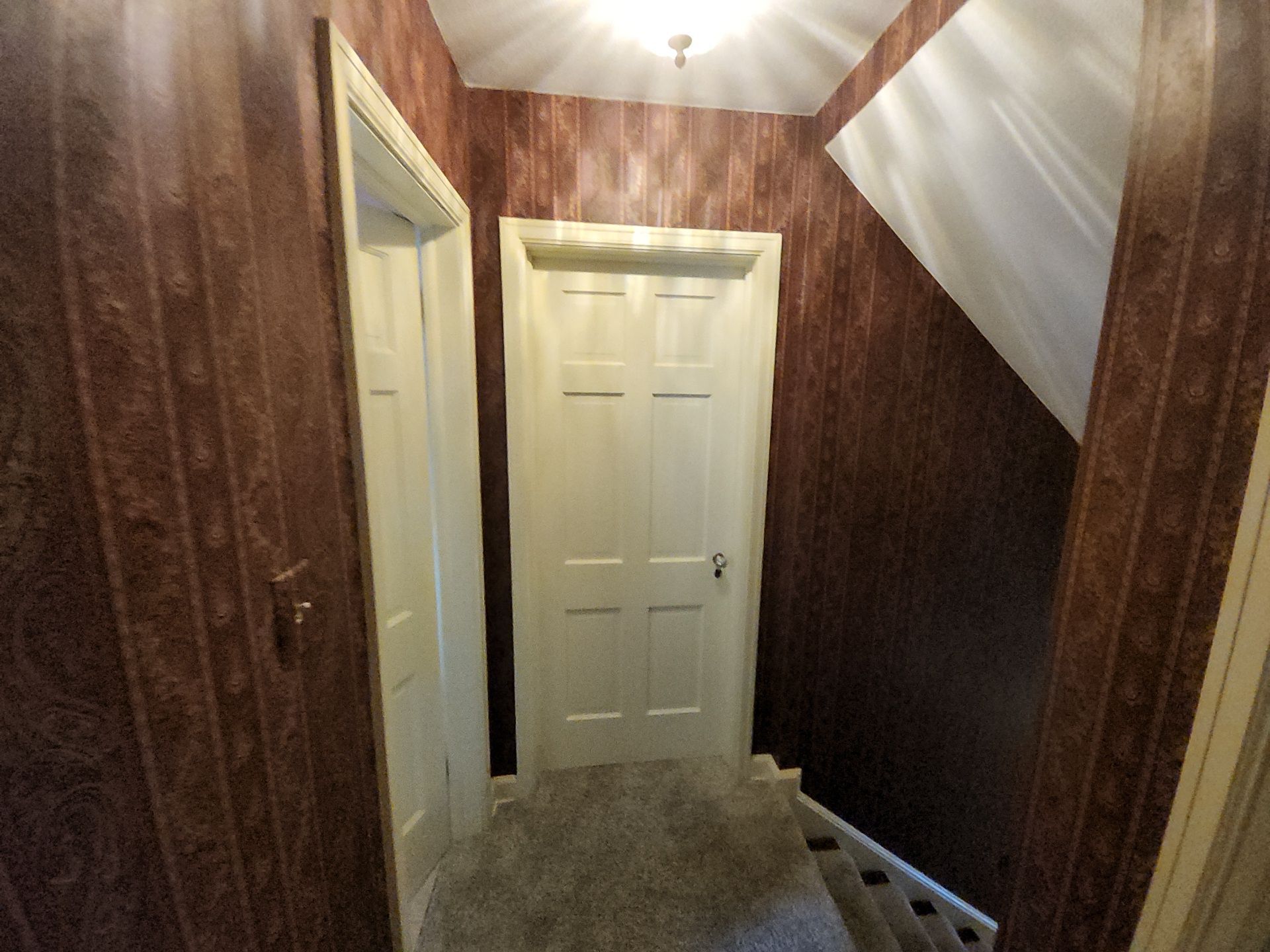 Original patterned wallcovering beside a Wauwatosa stairway