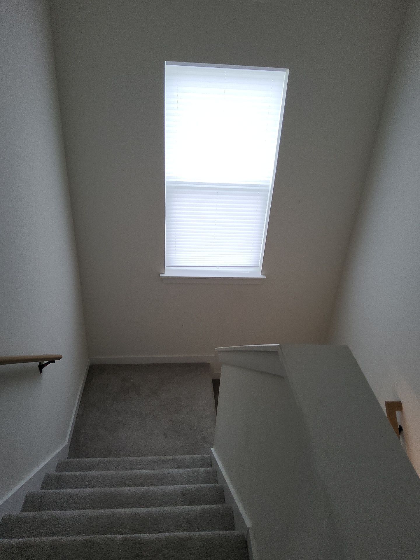 West Allis interior stairwell with neutral walls and white window trim