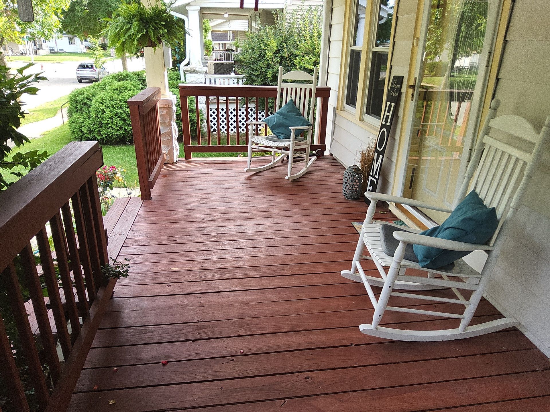 West Allis front porch with reddish-brown decking and railings