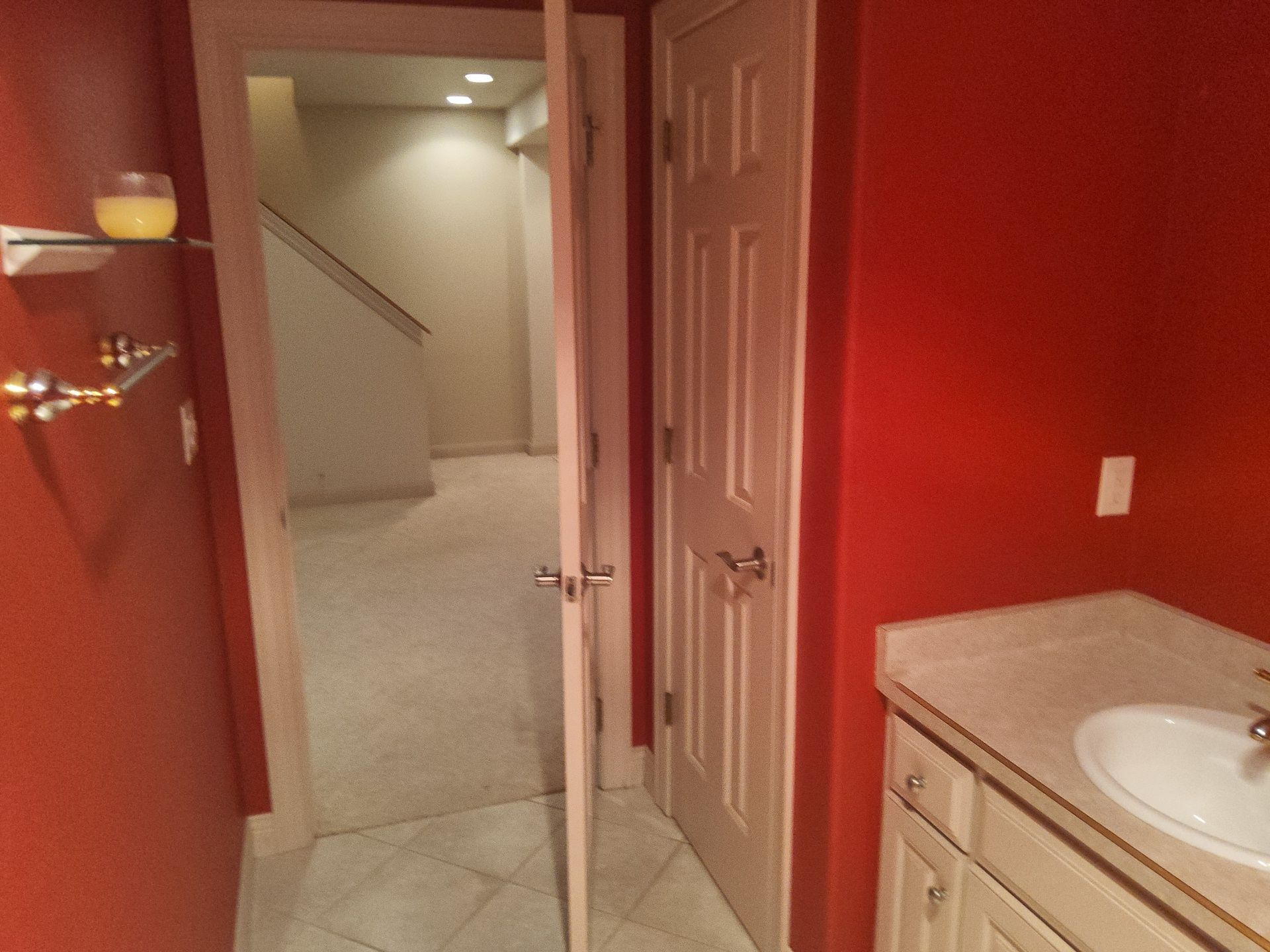 Franklin residential bathroom with red walls and white doors and trim