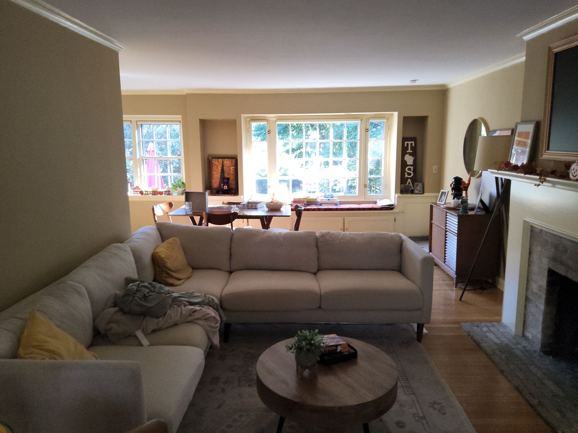 Wauwatosa living room with warm painted walls, white window trim and a fireplace