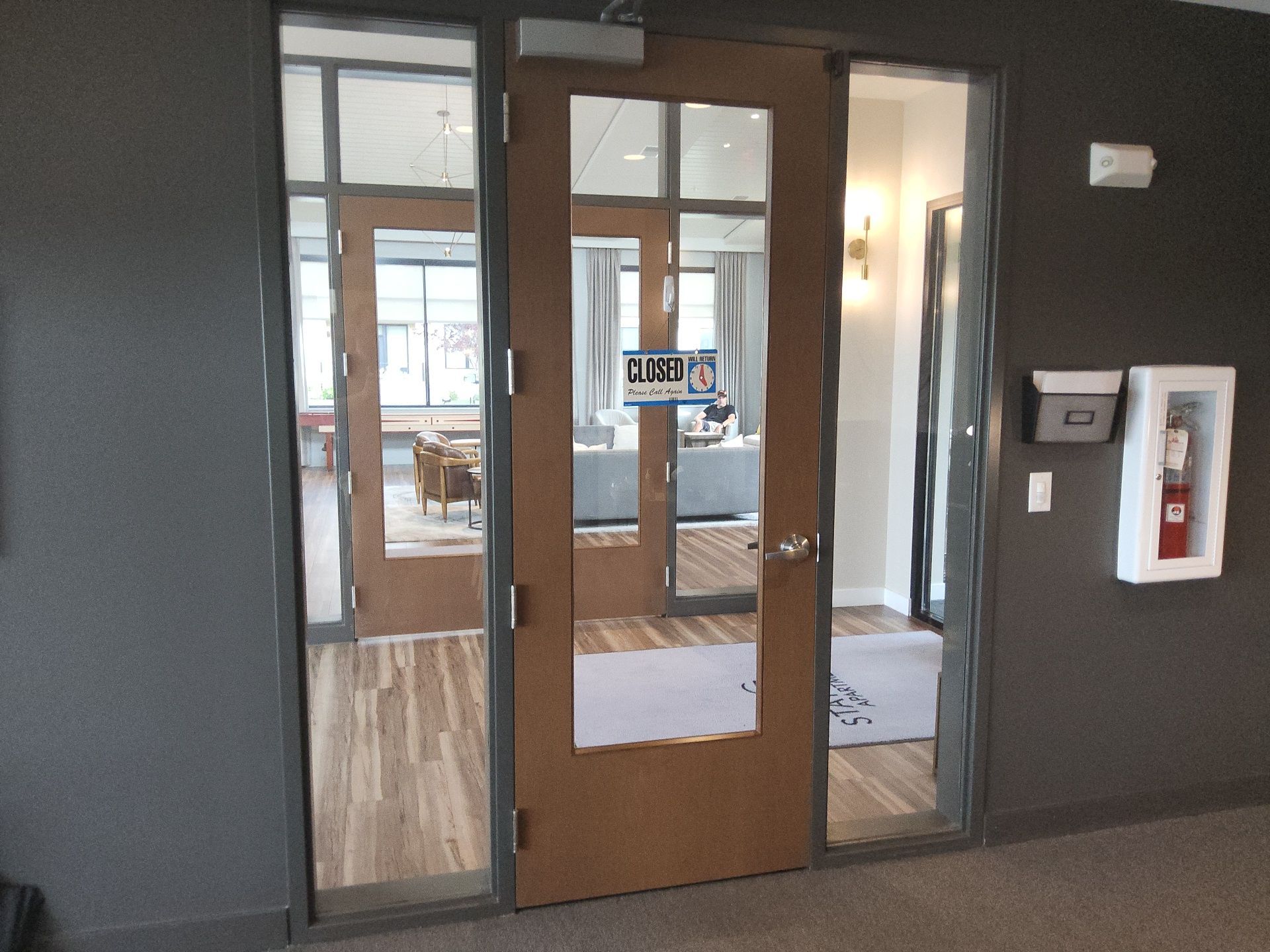 Franklin commercial entrance with charcoal walls and wood-framed glass doors
