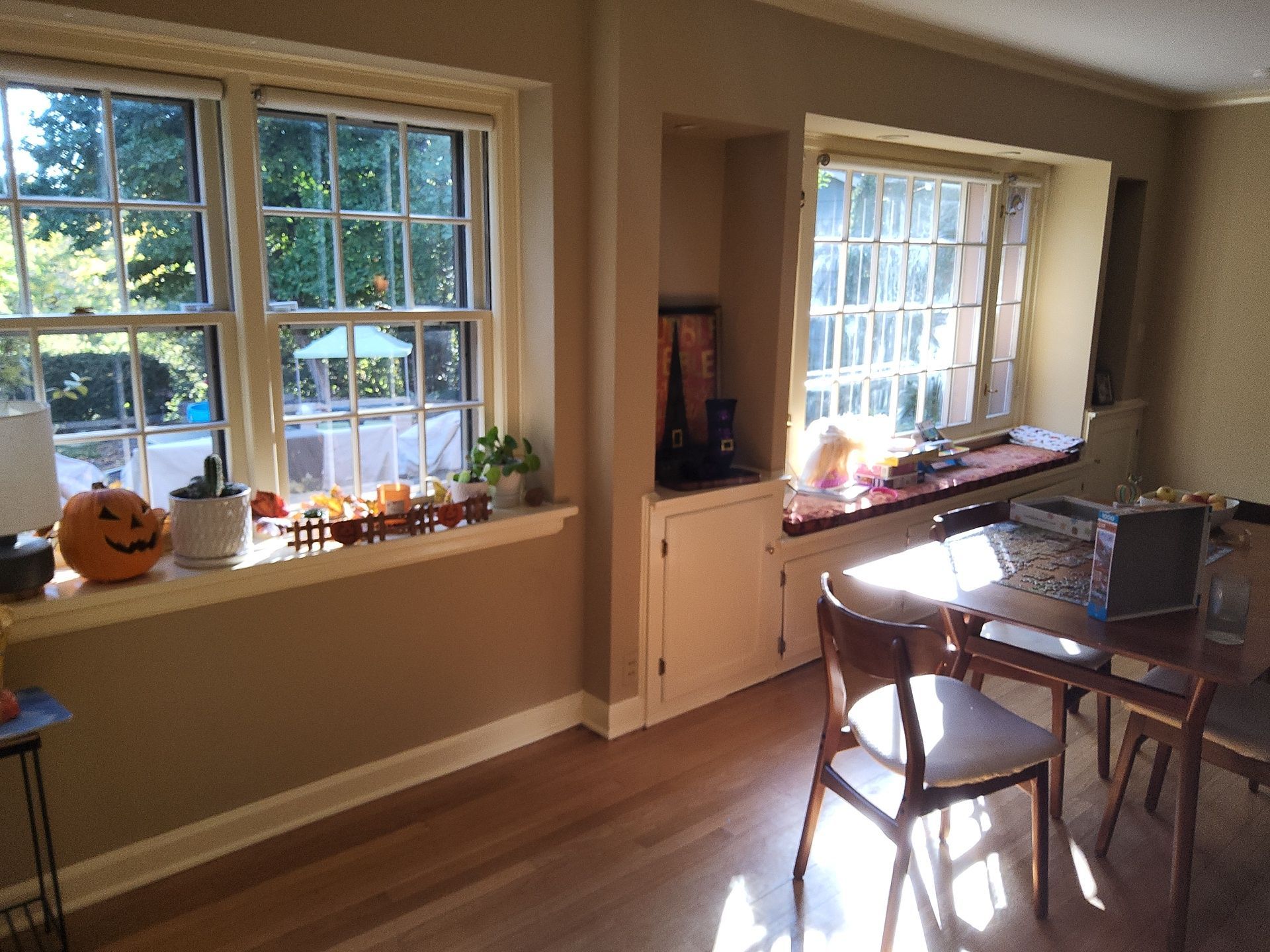 Wauwatosa dining room with warm painted walls, white window trim and built-in cabinetry