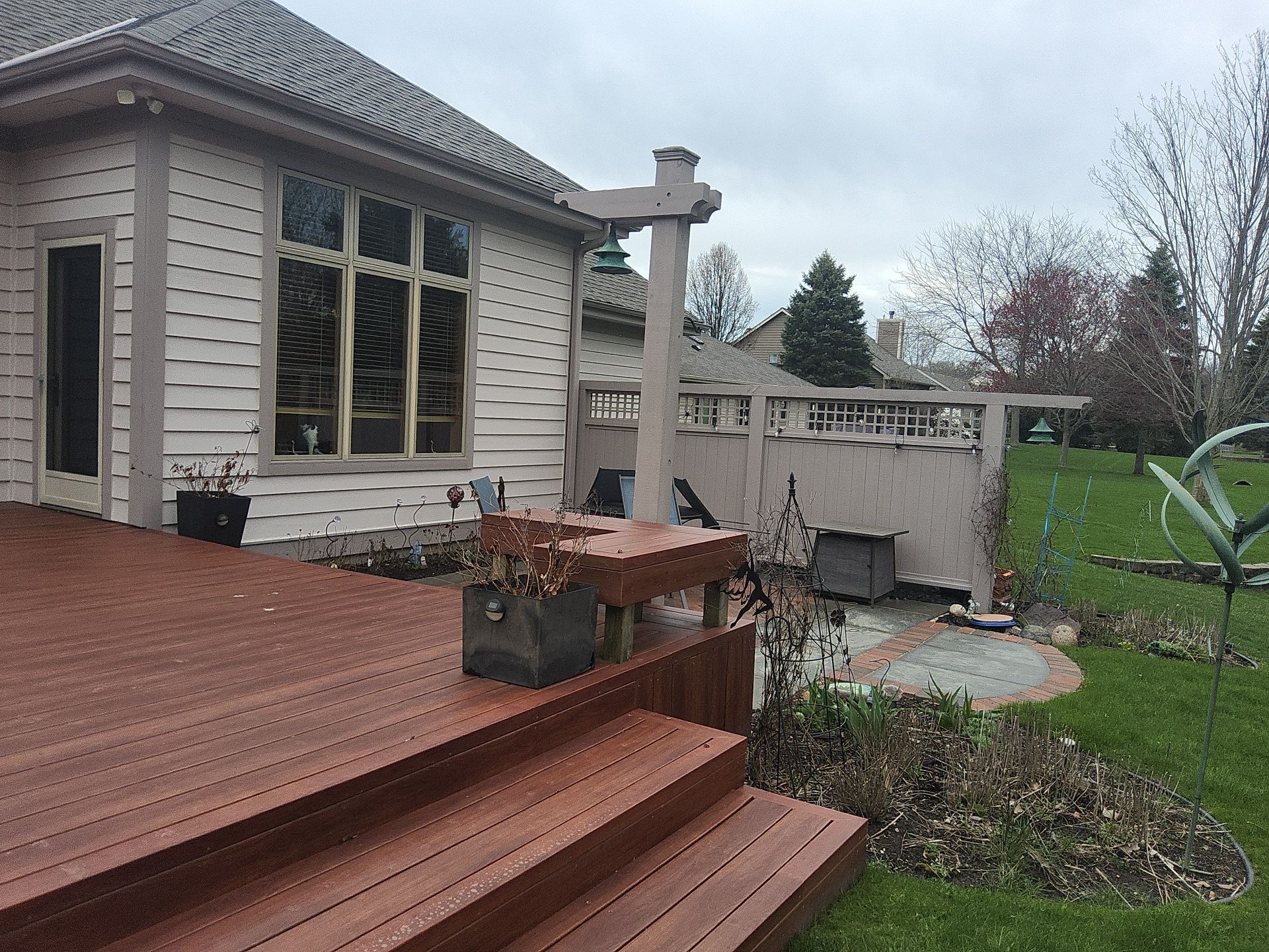 Franklin home exterior with light siding, a wood deck and garden