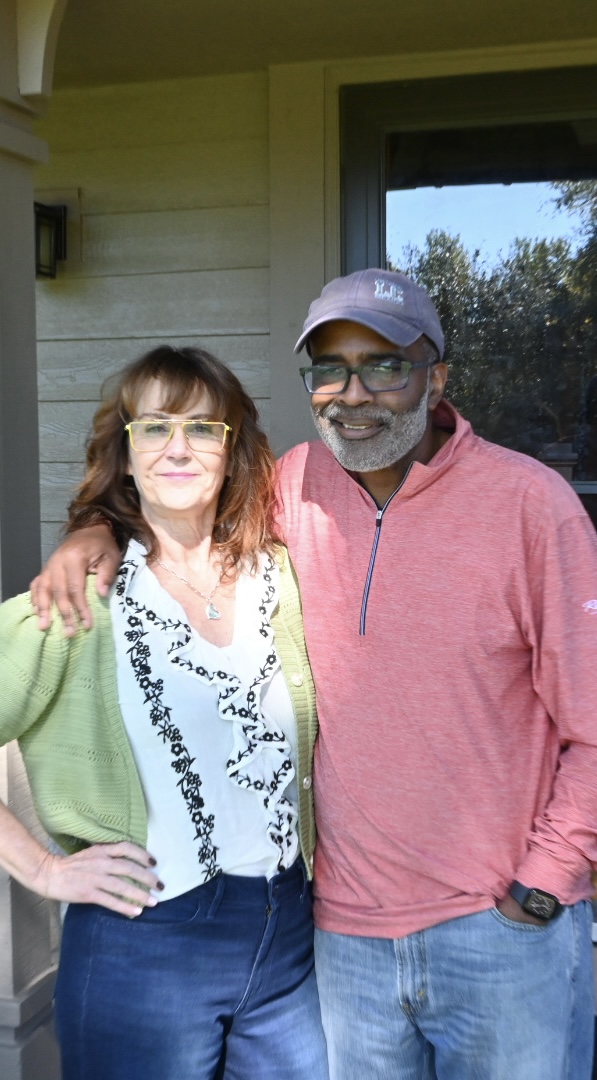 Mequon homeowners smiling together on their front porch