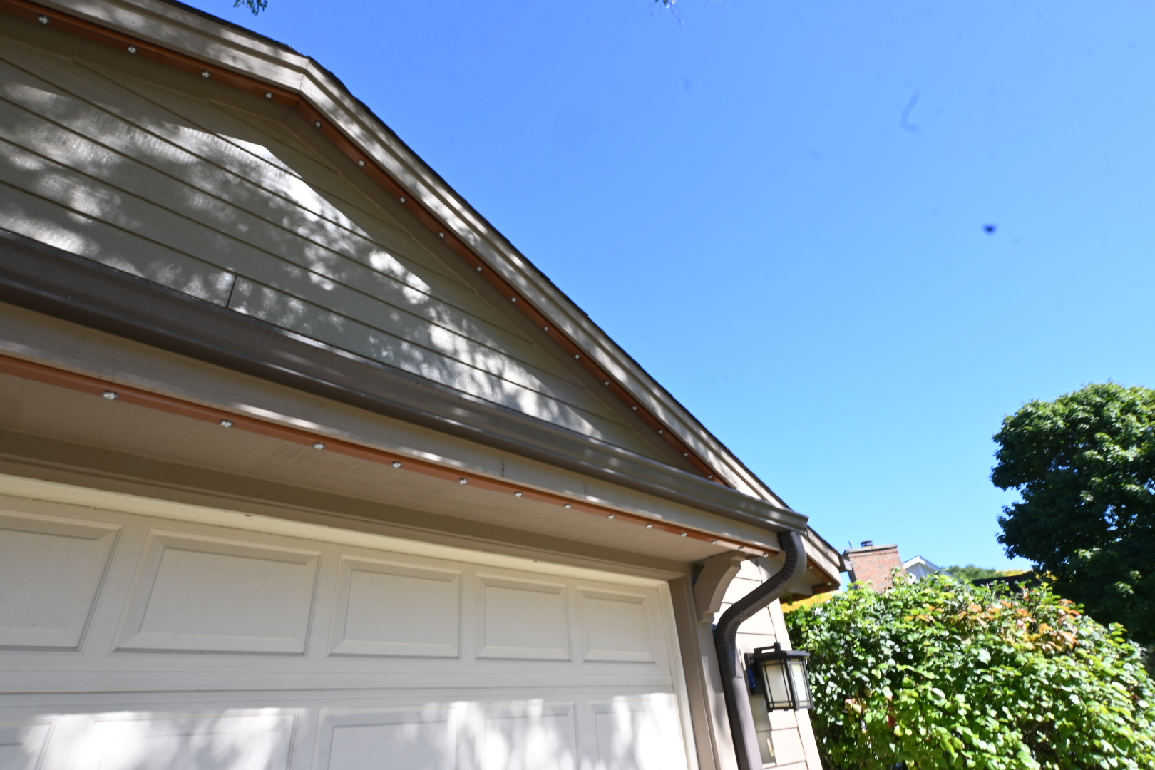 Siding and contrasting trim at the garage gable.