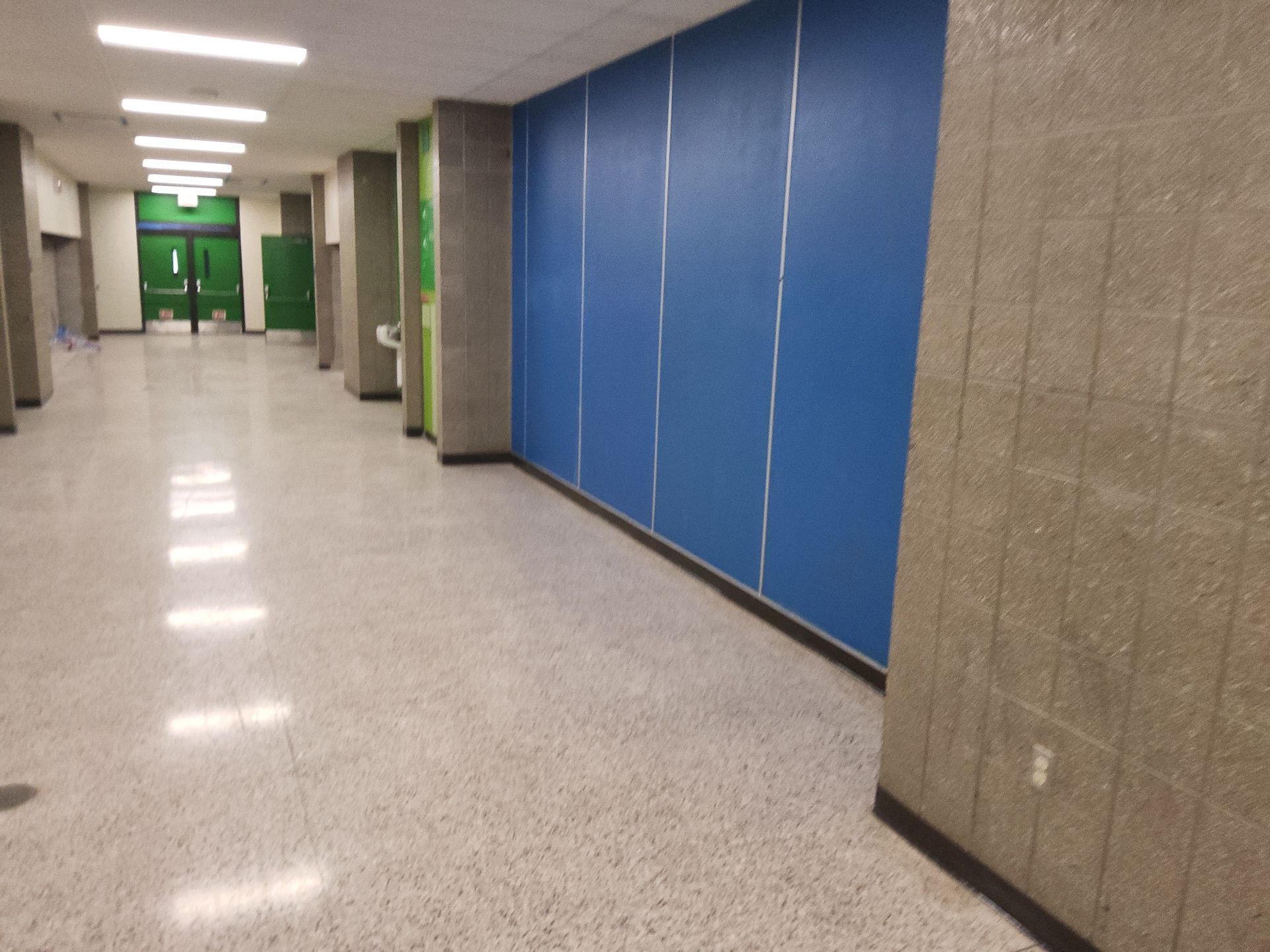 Painted blue corridor walls and green doors at the W Center Street school in Milwaukee