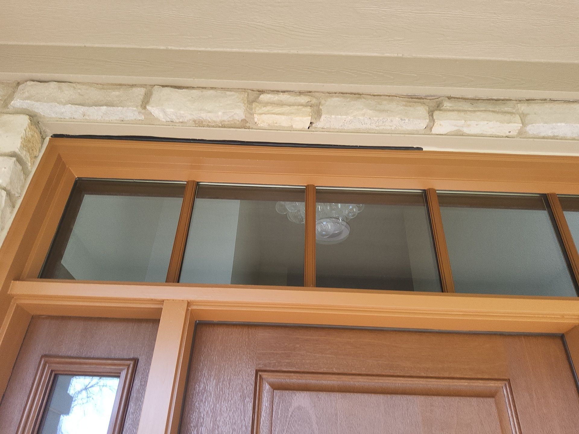 Wood door transom and trim at a Colgate home