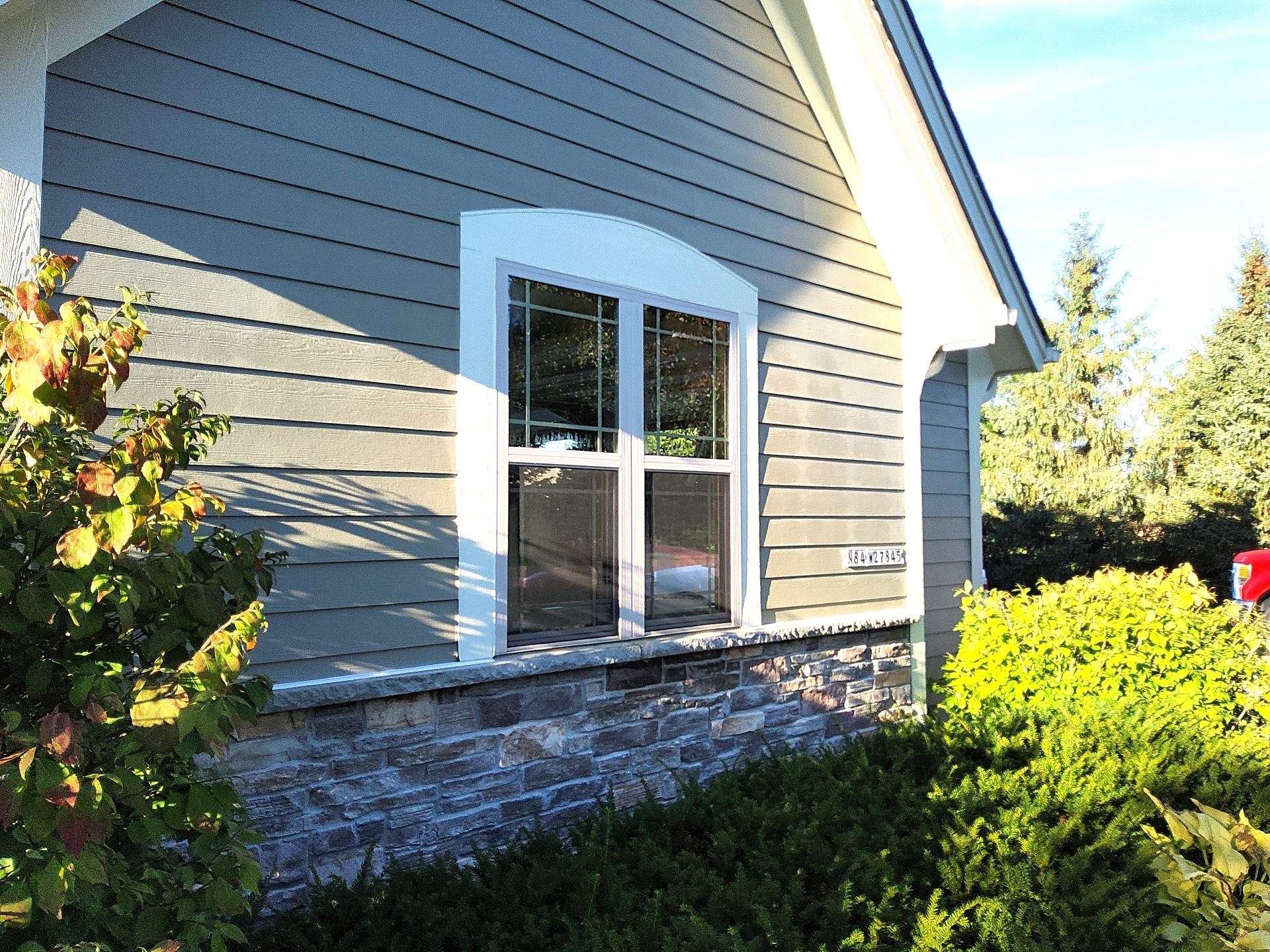 Painted siding and white window trim on a Hartland home