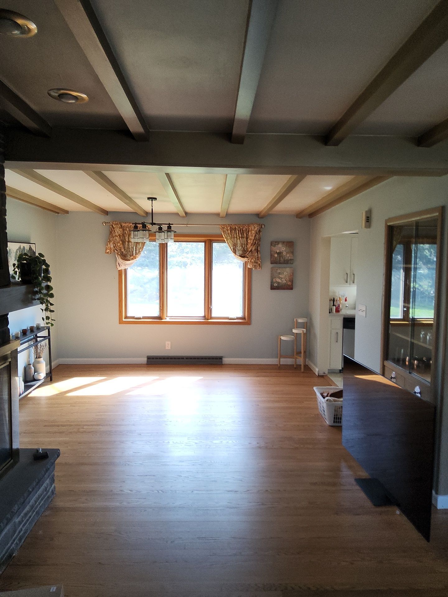 Franklin residential dining area with light walls and wood ceiling beams