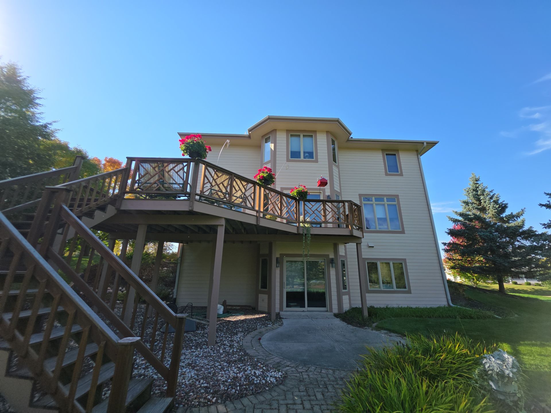 Finished Hartland rear exterior with deck stairs, railings and landscaping