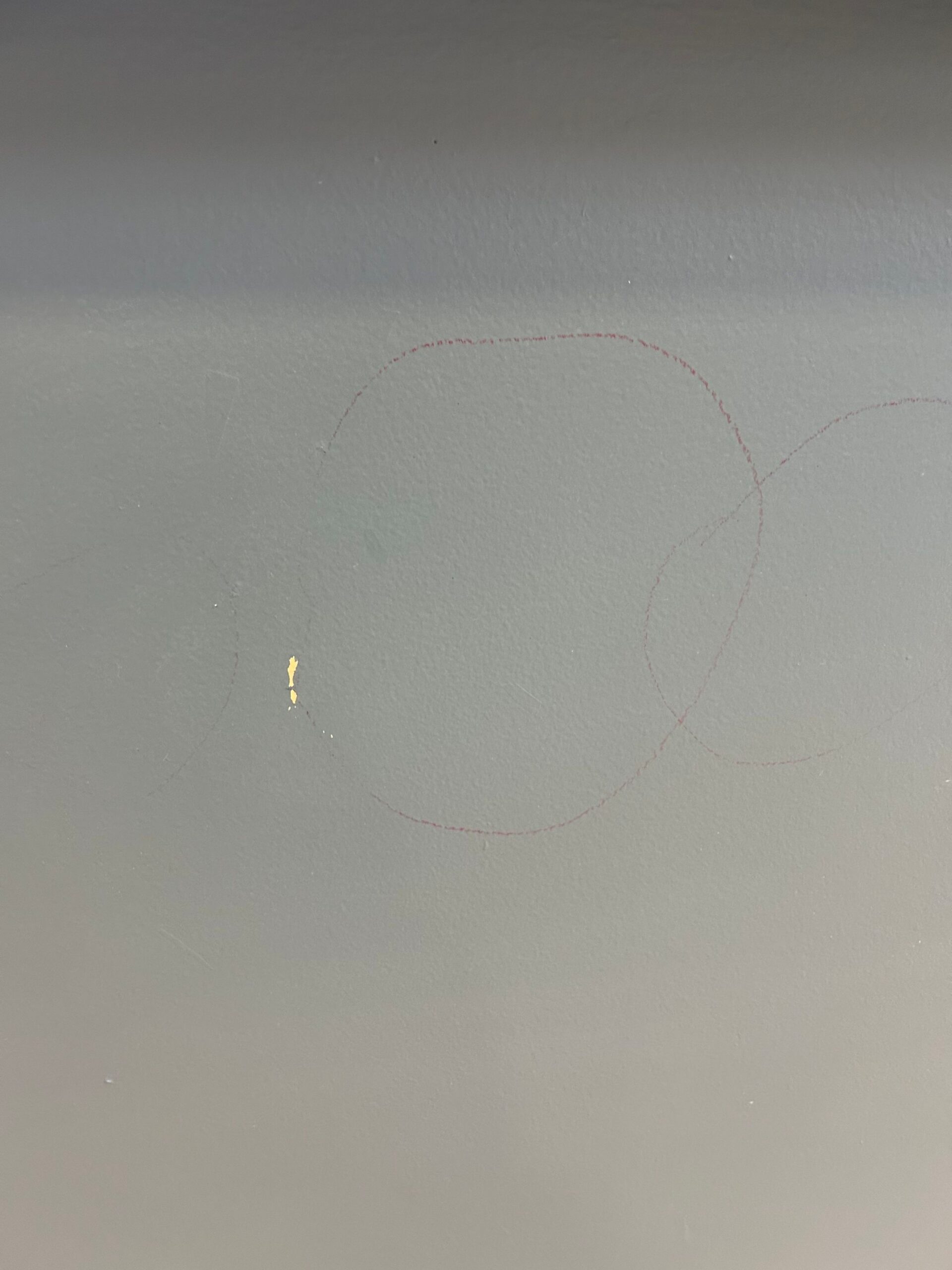 Before · medical-office wall damage — Lake Country Pediatrics — chipped wall areas marked for attention. Before-condition photo; no completed repair is claimed.