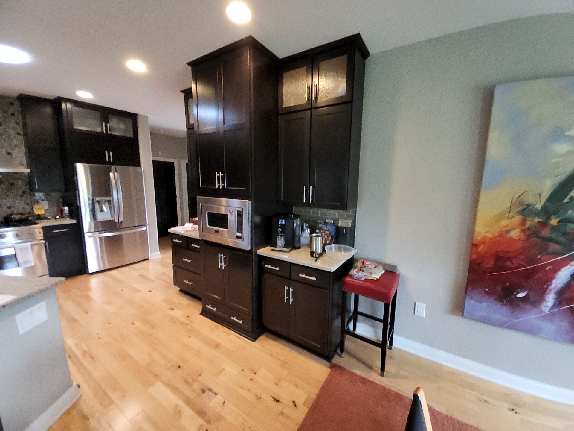 Tall dark cabinets beside the kitchen