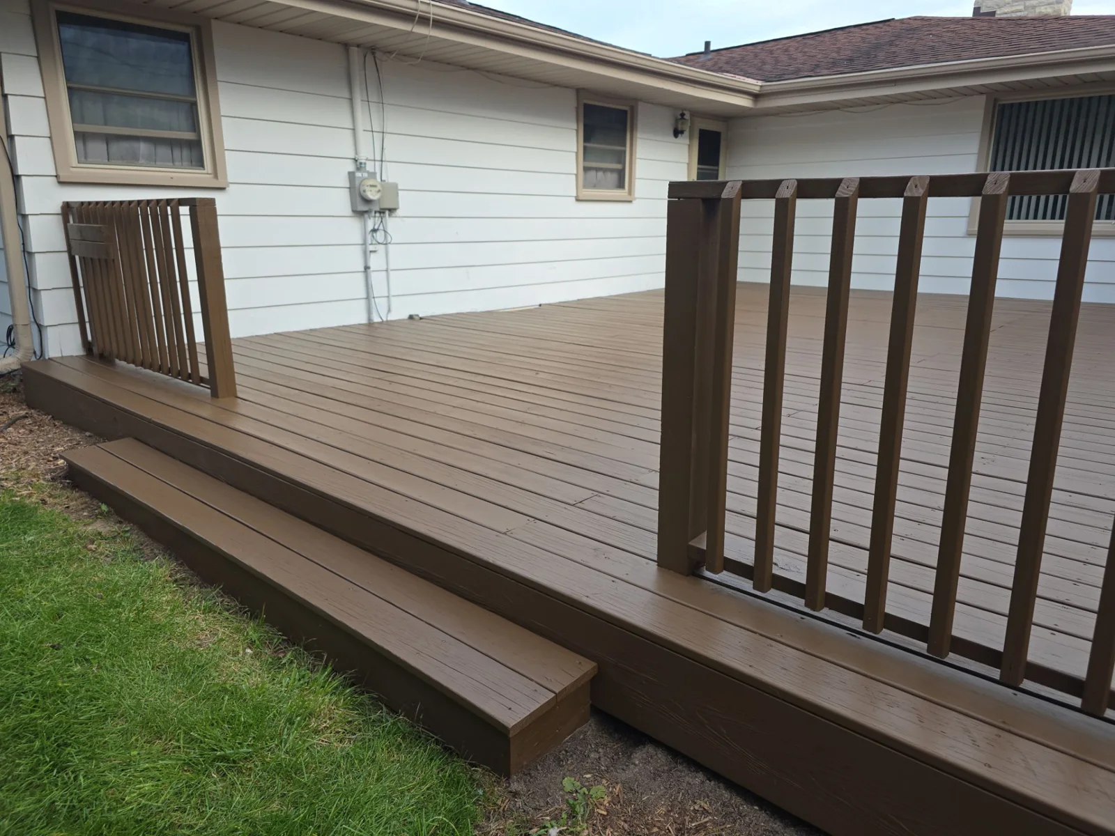 Finished brown deck and railings at a Menomonee Falls home
