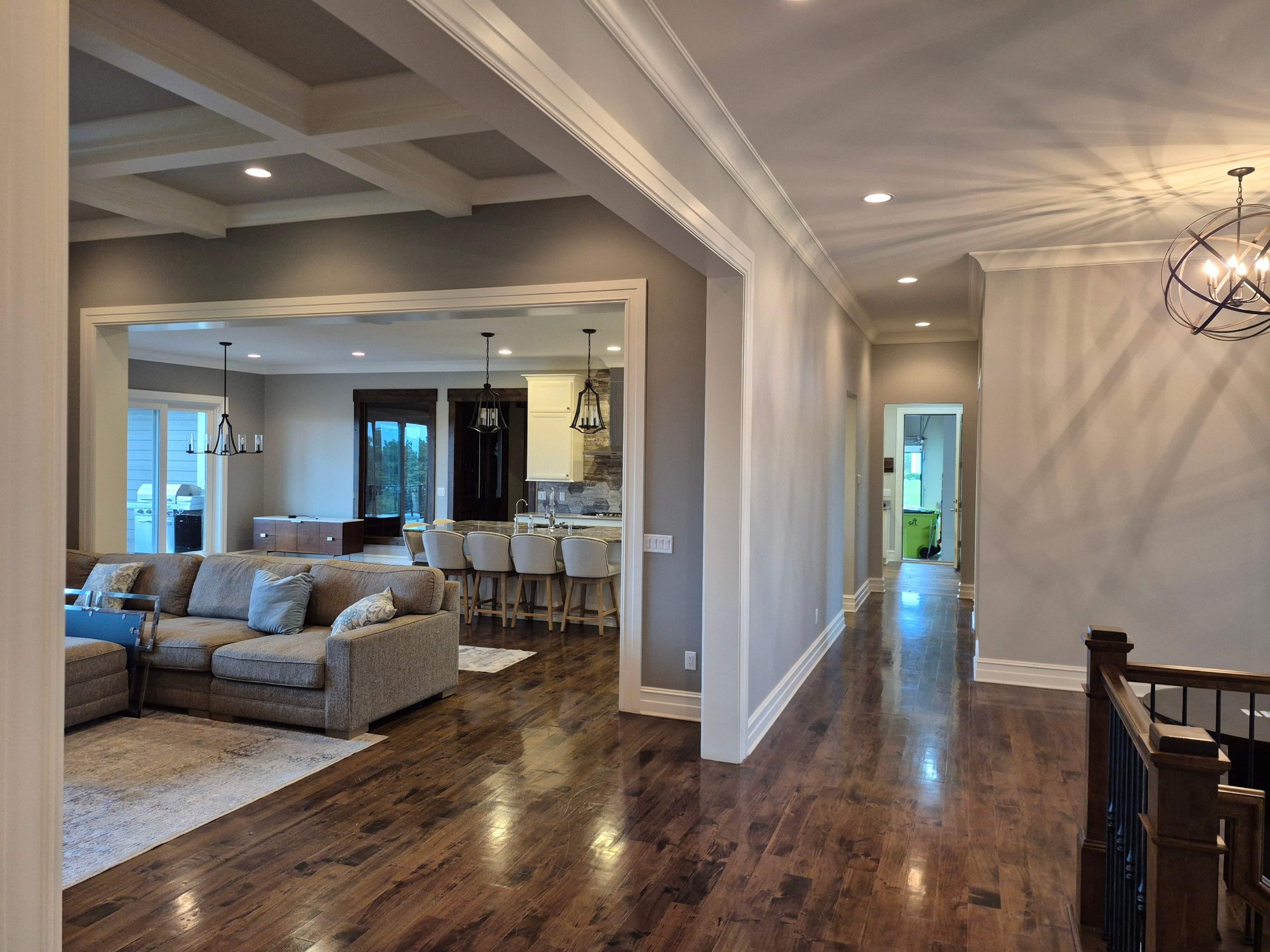 Freshly painted Hartland living spaces with wood floors and a stone fireplace